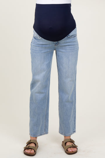woman wearing light blue maternity jeans with a dark blue over-the-bump band