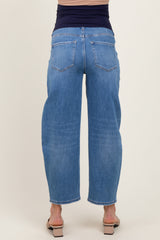 woman wearing light blue maternity jeans with a relaxed fit and cropped length viewed from the back