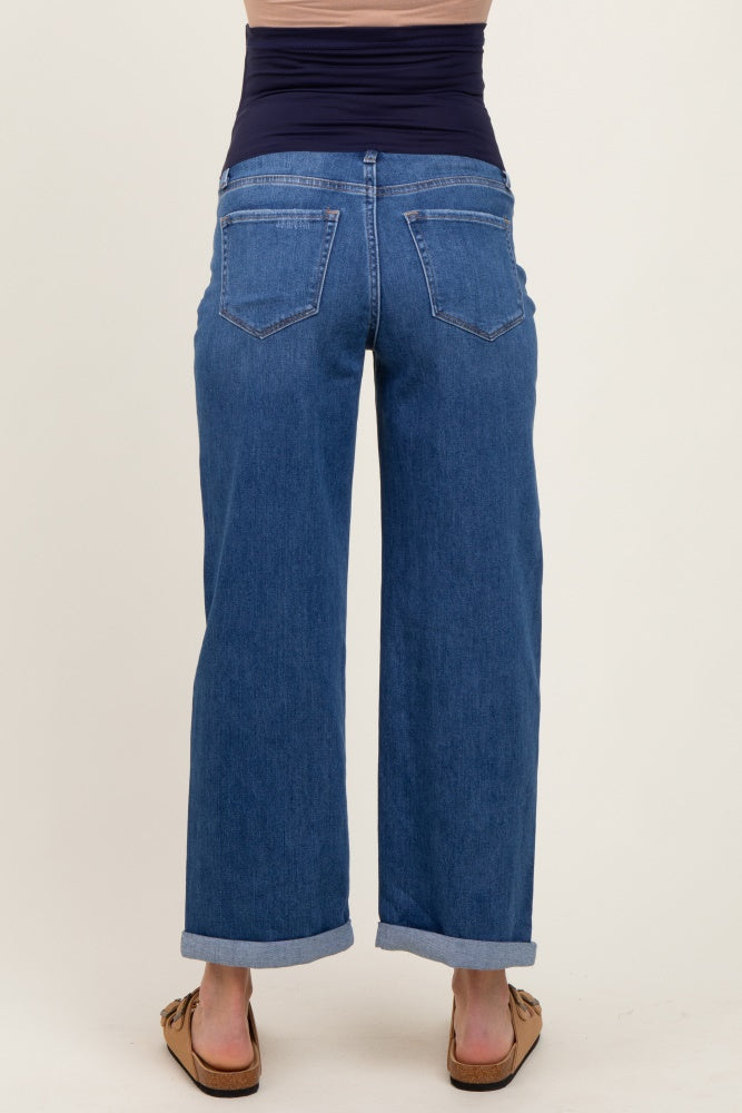maternity wear: woman wearing a pair of blue wide-leg jeans with a stretchy waistband and rolled cuffs from the back