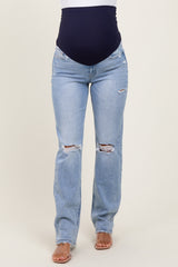 woman wearing light blue distressed maternity jeans with a dark blue over-the-bump waistband