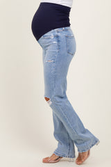 woman wearing light blue ripped maternity jeans with a black belly panel and a visible baby bump