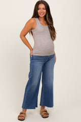 woman wearing a gray ribbed maternity tank top and wide-leg jeans, showing her baby bump
