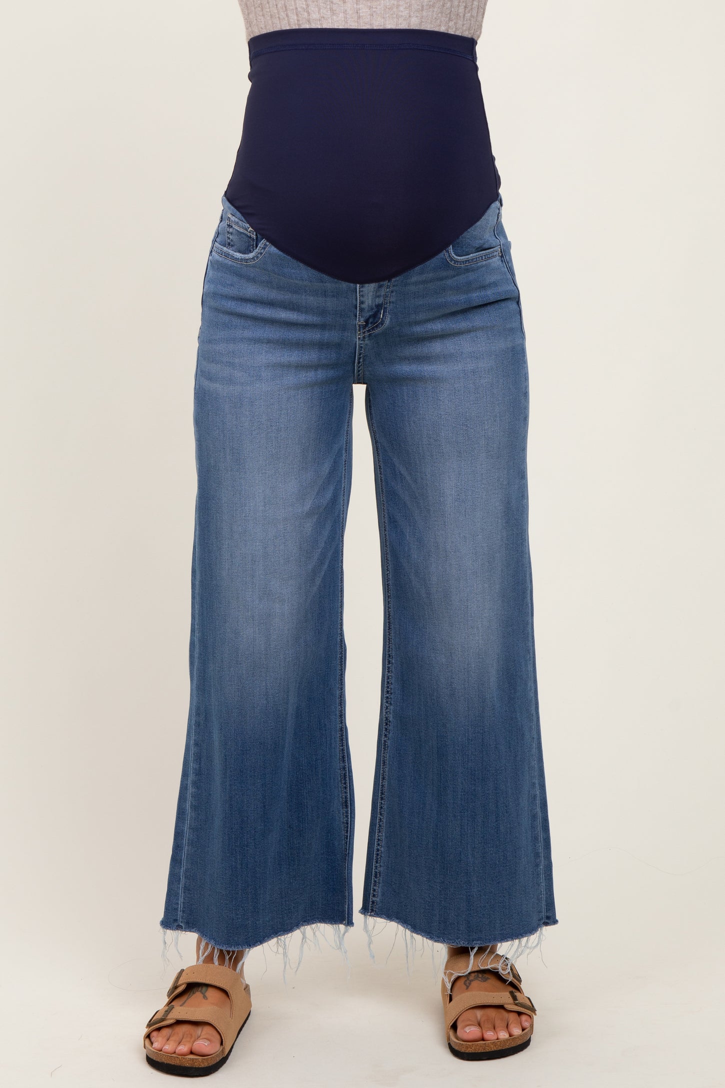 woman wearing light blue maternity wide-leg jeans with a dark blue over-the-bump band