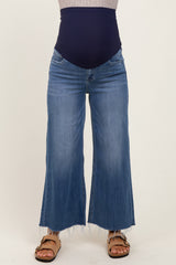 woman wearing light blue maternity wide-leg jeans with a dark blue over-the-bump band