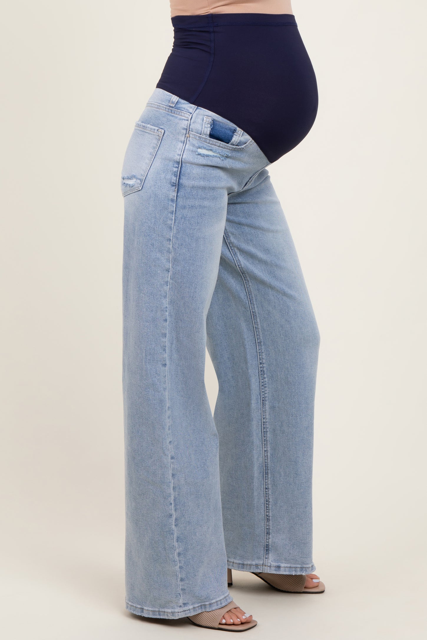 maternity wear featuring light blue wide-leg jeans with a high-rise stretch waistband, model showing a baby bump