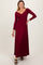 woman wearing a burgundy long sleeve maxi dress with a v-neckline and gathered waist detail