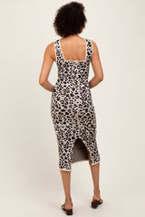 woman wearing a leopard print midi dress with a back slit and fitted silhouette