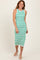 woman wearing a white and green stripe midi dress with a sleeveless design and a fitted silhouette
