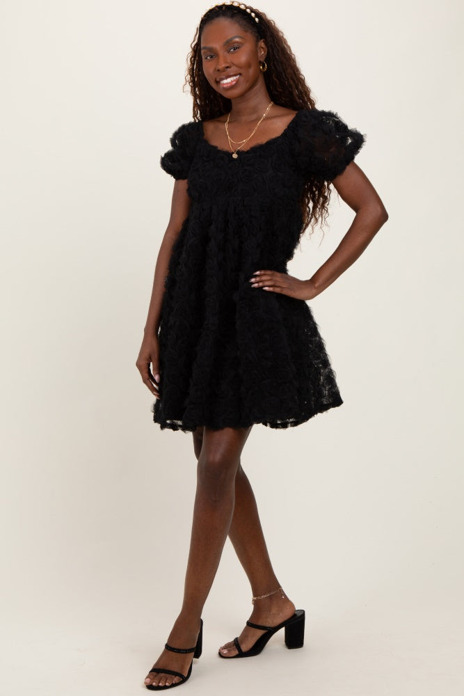 woman wearing a black floral short sleeve dress with a flared skirt and heeled sandals