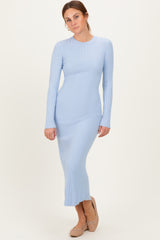woman wearing a light blue ribbed long sleeve dress that falls to the ankles