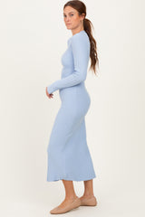 woman wearing a light blue ribbed long sleeve midi dress and beige flats