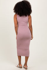 woman wearing a back view of a fitted pink and white striped midi dress with a ribbed texture