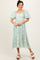 woman wearing a mint green floral midi dress with puff sleeves and a square neckline