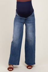 maternity wear wide-leg blue jeans with a supportive belly band, model standing with feet apart