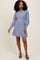 woman wearing a light blue long sleeve sweater dress with puff sleeves and a relaxed fit