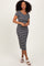 woman wearing a black and white striped midi dress with a square neckline and short sleeves