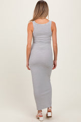 woman wearing a striped maternity maxi dress, showing a fitted silhouette from the back