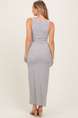 woman wearing a gray and white striped maxi dress with a fitted silhouette, shown from the back
