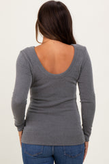 woman wearing a fitted gray ribbed maternity top with a scoop back and long sleeves