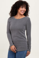 woman wearing a gray long sleeve ribbed top with a round neckline and smiling
