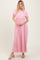 woman wearing a pink short sleeve maxi dress with a gathered waist and flowy silhouette