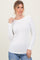 woman wearing a white long sleeve ribbed top and blue jeans