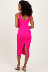 woman wearing a hot pink ribbed midi dress with a back slit and a scoop neckline