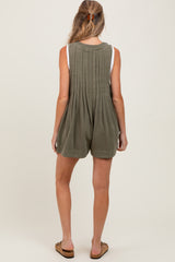 woman wearing a green maternity romper with pleated back and casual shorts style