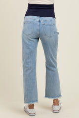 woman wearing light blue maternity jeans with a frayed hem, showing the back view, ideal for comfort during pregnancy