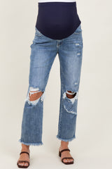 woman wearing light blue distressed maternity jeans with a navy band, featuring ripped details and frayed hems