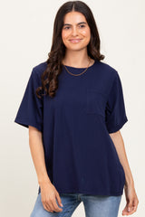 woman wearing a navy blue oversized t-shirt with a front pocket and relaxed sleeves, paired with blue jeans