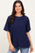 woman wearing a navy blue oversized t-shirt with a front pocket and relaxed sleeves, paired with blue jeans