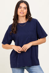 woman wearing a navy oversized t-shirt with a pocket and rolled sleeves, styled with light blue jeans