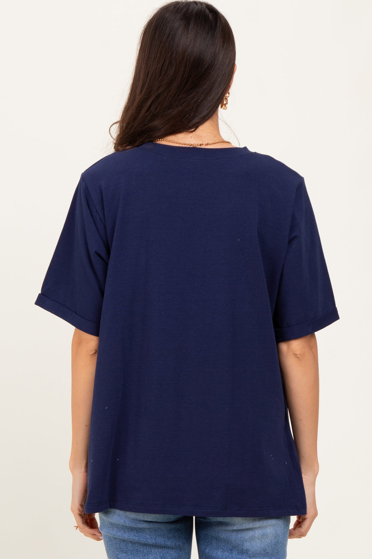 woman wearing a navy blue oversized t-shirt with short sleeves, viewed from the back