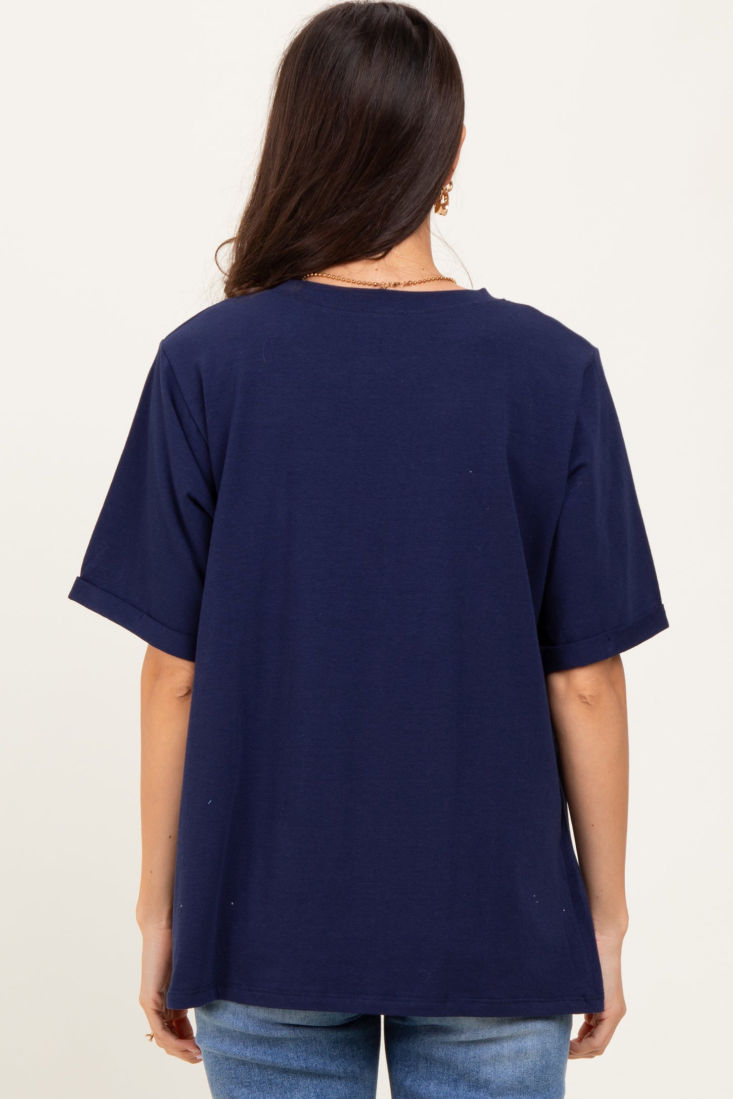 woman wearing a navy blue oversized t-shirt with short sleeves, viewed from the back