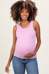 woman wearing a pink ribbed maternity tank top and holding her baby bump