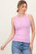 woman wearing a pink ribbed tank top with a round neckline and styled with light blue distressed jeans