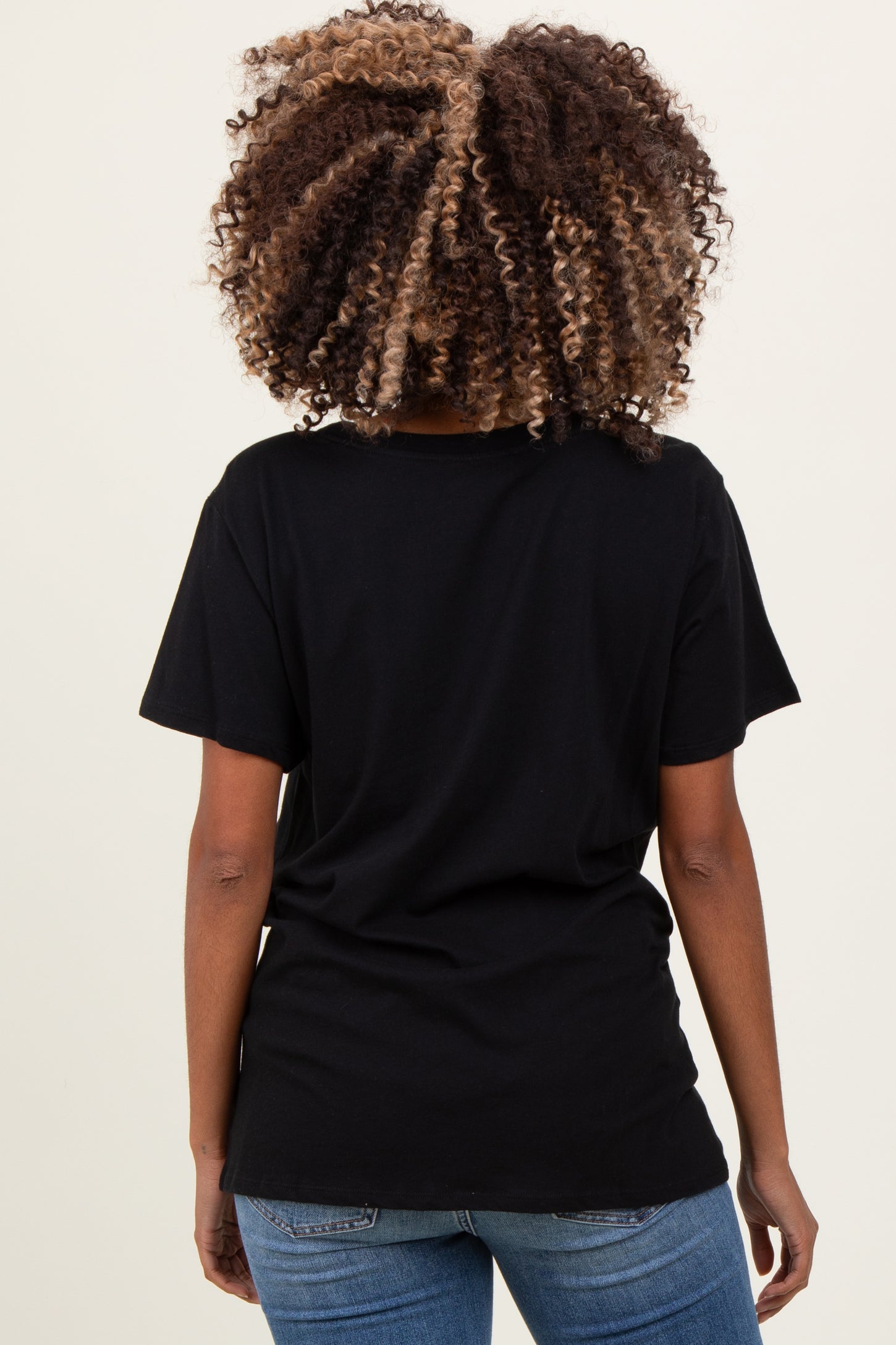 woman wearing a black short sleeve maternity t-shirt, showing the back view
