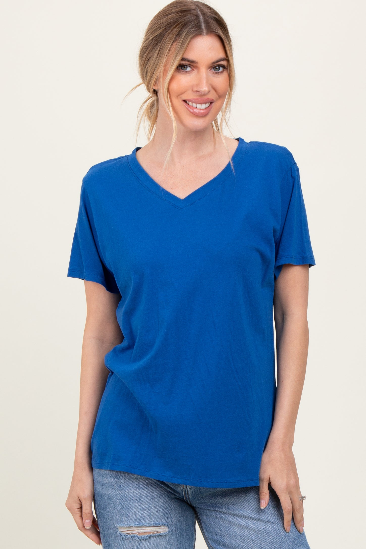 woman wearing a bright blue v-neck t-shirt with short sleeves and casual styling