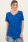 woman wearing a bright blue v-neck t-shirt with short sleeves and casual styling