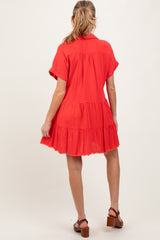 woman wearing a red short sleeve tiered maternity dress, showing the back view and a relaxed fit