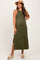 woman wearing an olive green maternity maxi dress with side slits and a straw hat, showing her baby bump