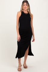 woman wearing a black ribbed maternity dress with a side slit and spaghetti straps, showcasing her baby bump