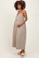 woman wearing a beige striped maternity dress with a v-neck and holding her baby bump