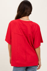 woman wearing a red oversized short sleeve t-shirt with back seam detail and casual style