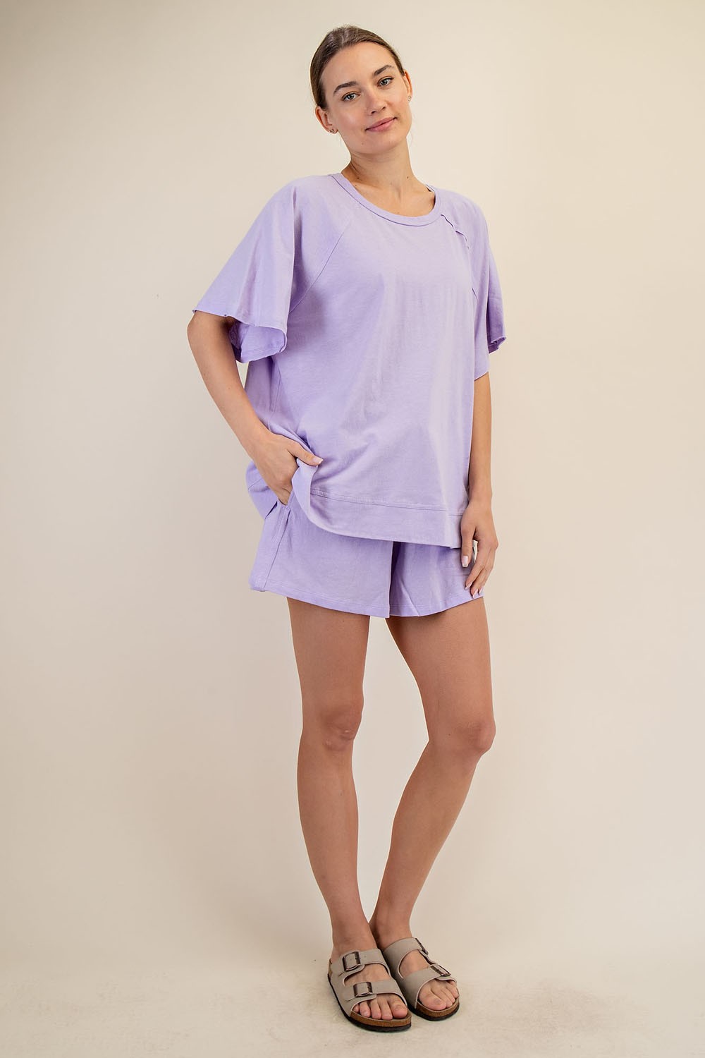 woman wearing a light purple oversized t-shirt and matching shorts in a relaxed fit