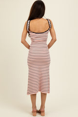 woman wearing a fitted pink and black striped midi dress with spaghetti straps and a scoop back