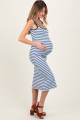 woman wearing a navy and white striped maternity dress, highlighting her baby bump