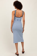 woman wearing a light blue and navy striped midi dress with a fitted style and wide shoulder straps, viewed from the back