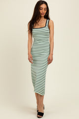 woman wearing a green and black striped fitted midi dress with a square neckline and spaghetti straps